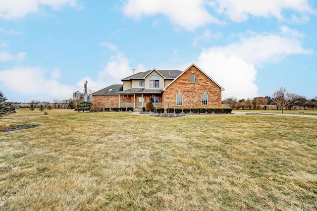 traditional home with a front lawn and brick siding