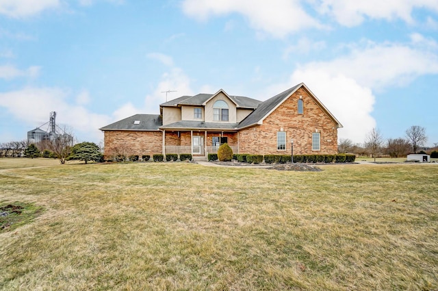 traditional home with brick siding and a front lawn