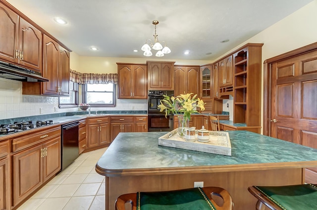 kitchen featuring dark countertops, black appliances, a kitchen island, and brown cabinets