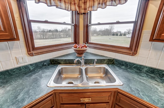 details featuring dark countertops, brown cabinets, a sink, and a jacuzzi