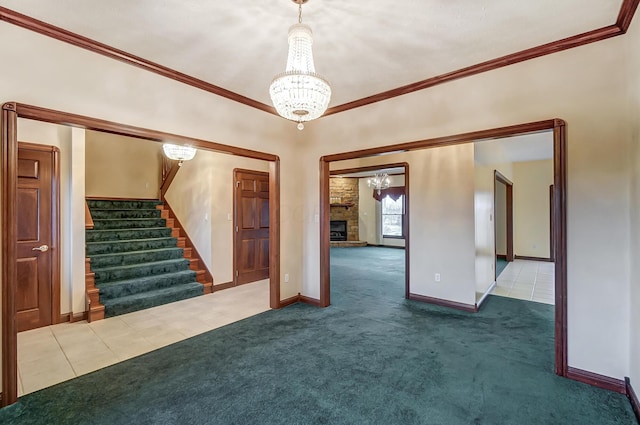 interior space featuring a fireplace, stairway, dark colored carpet, and crown molding