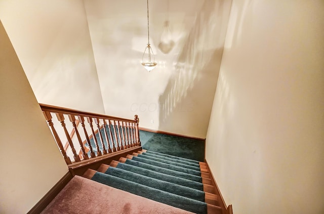 stairway with carpet and baseboards