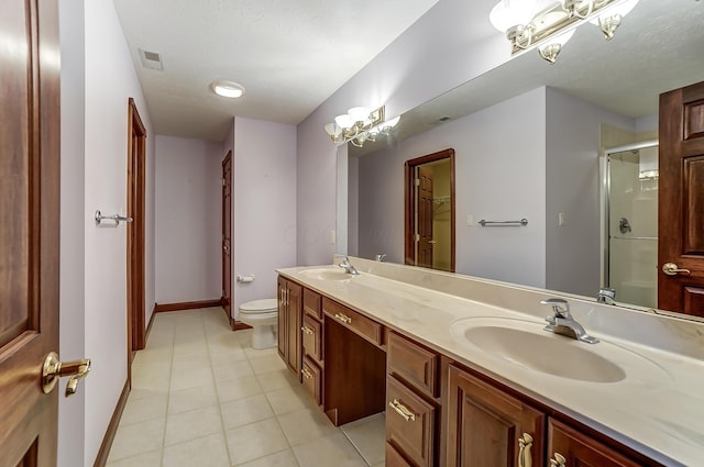 bathroom with toilet, a shower with shower door, a sink, and visible vents