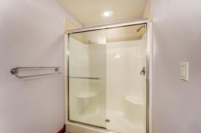 full bath with a shower stall