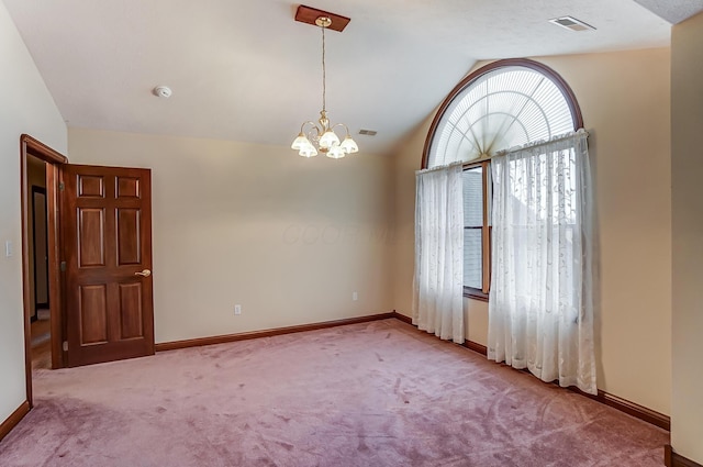 carpeted spare room with visible vents, baseboards, vaulted ceiling, and a notable chandelier