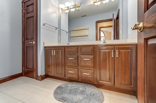 full bathroom featuring a notable chandelier, a sink, visible vents, tile patterned floors, and double vanity