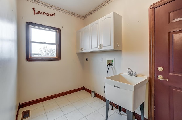 laundry area with washer hookup, a sink, baseboards, cabinet space, and electric dryer hookup