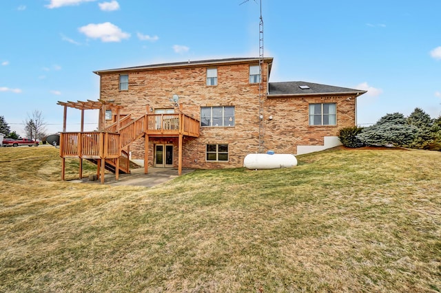 rear view of house featuring a lawn, stairway, a deck, a pergola, and brick siding