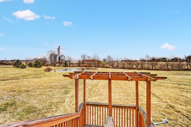 deck with a rural view and a lawn