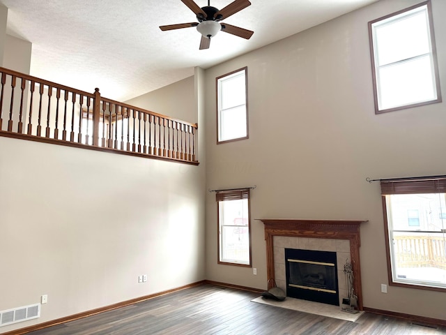 unfurnished living room featuring wood finished floors, visible vents, and baseboards