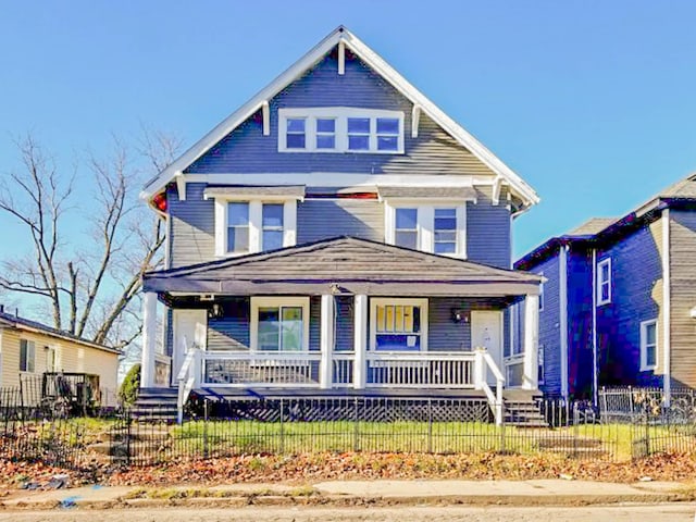 view of front of property featuring a porch and a fenced front yard