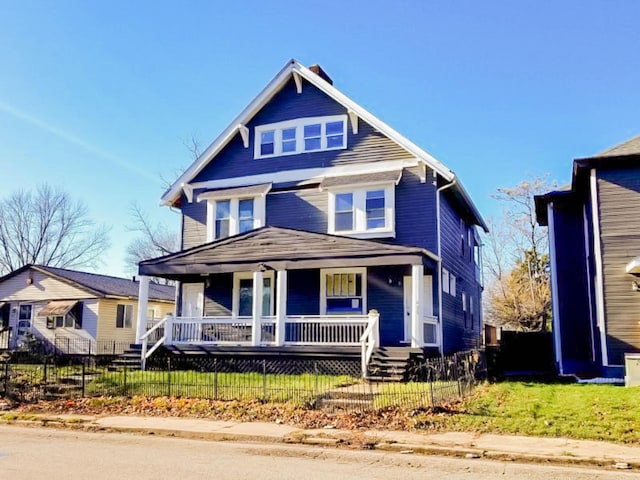 view of front of home featuring a porch and a fenced front yard