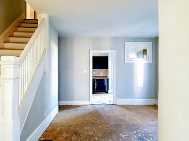 interior space featuring stairs and baseboards