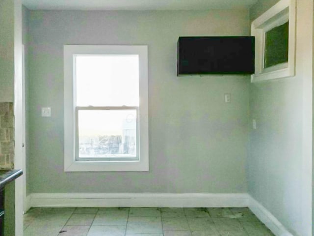 empty room featuring baseboards