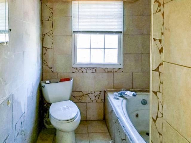 full bath featuring tile patterned flooring, a garden tub, tile walls, and toilet