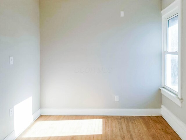 empty room featuring light wood-style flooring and baseboards