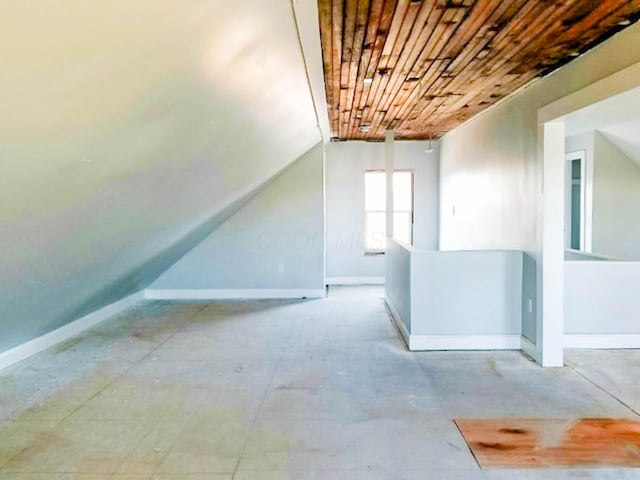 bonus room featuring lofted ceiling, wood ceiling, and baseboards