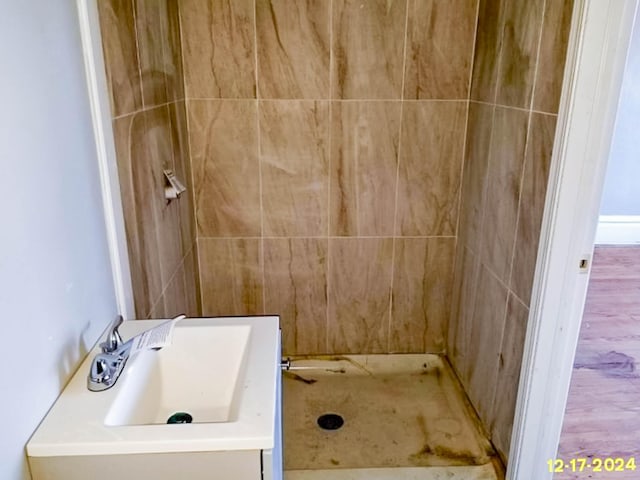 full bathroom with a stall shower and a sink