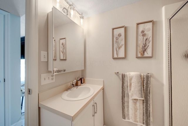 bathroom featuring a textured ceiling and vanity