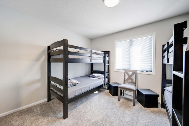 carpeted bedroom featuring baseboards