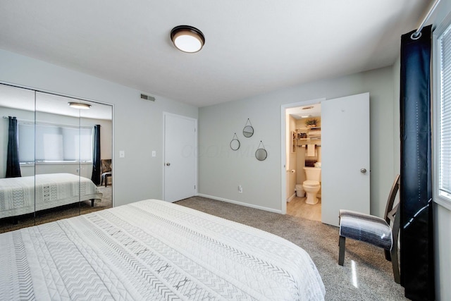 bedroom with carpet floors, a closet, visible vents, and baseboards