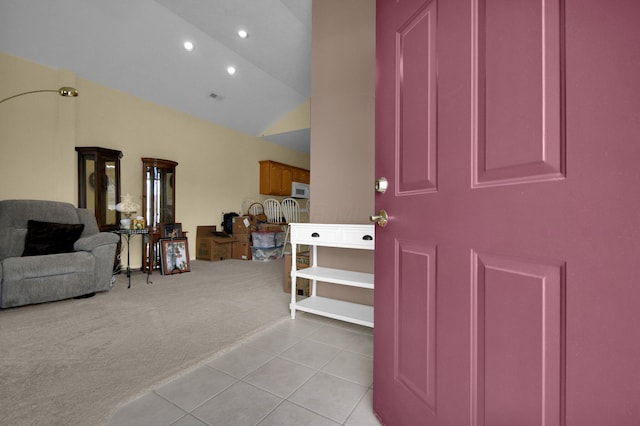 foyer entrance featuring light carpet, light tile patterned floors, recessed lighting, and lofted ceiling