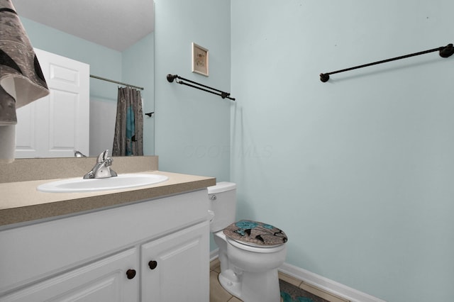 bathroom featuring a shower with curtain, toilet, vanity, tile patterned flooring, and baseboards