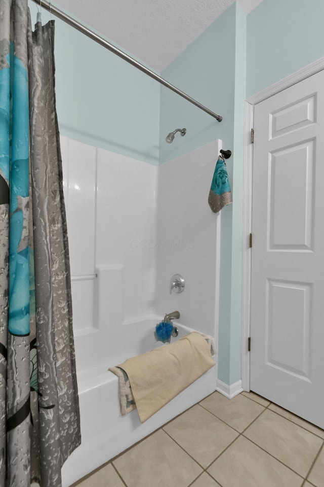 bathroom with tile patterned flooring and shower / bath combination with curtain