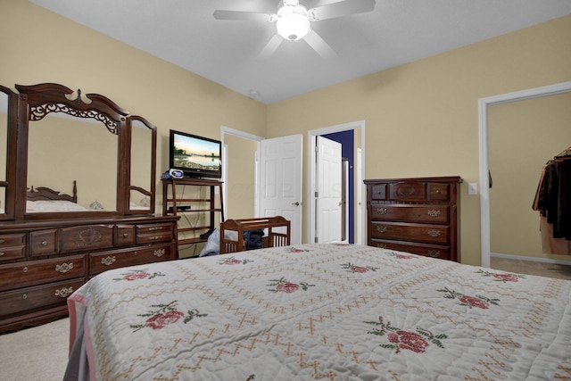 bedroom featuring a ceiling fan and light colored carpet