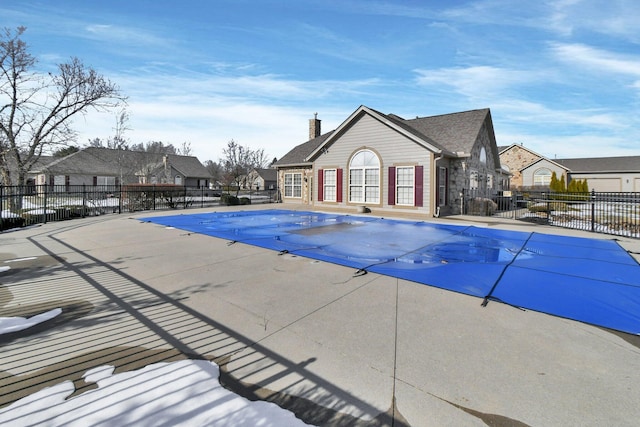 pool featuring a residential view, fence, and a patio