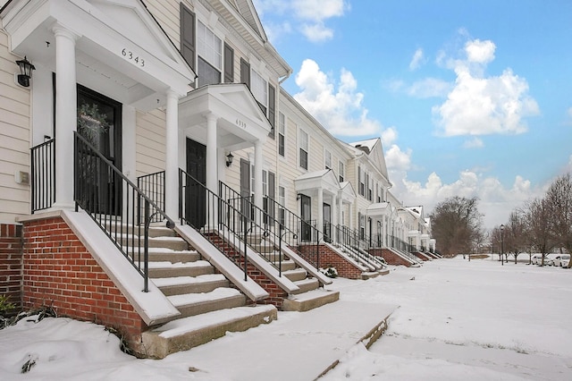 snow covered property featuring a residential view