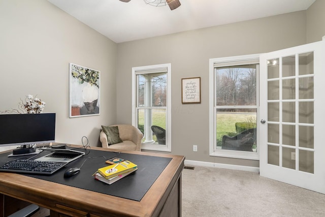 carpeted home office featuring visible vents, a ceiling fan, and baseboards