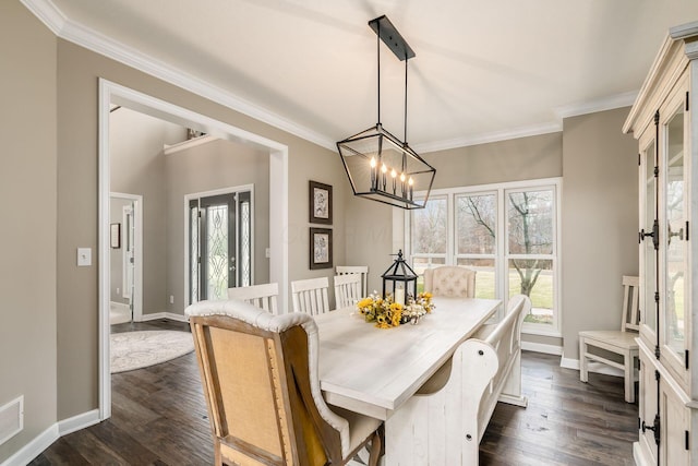 dining room featuring baseboards, ornamental molding, a chandelier, and dark wood-type flooring