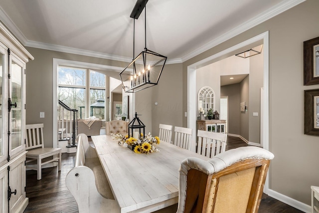 dining area featuring baseboards, dark wood finished floors, crown molding, and a chandelier