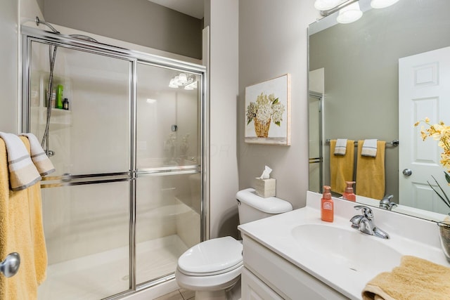 full bath with a stall shower, vanity, and toilet