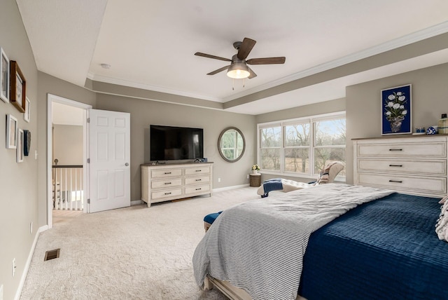 carpeted bedroom featuring a ceiling fan, baseboards, visible vents, and crown molding