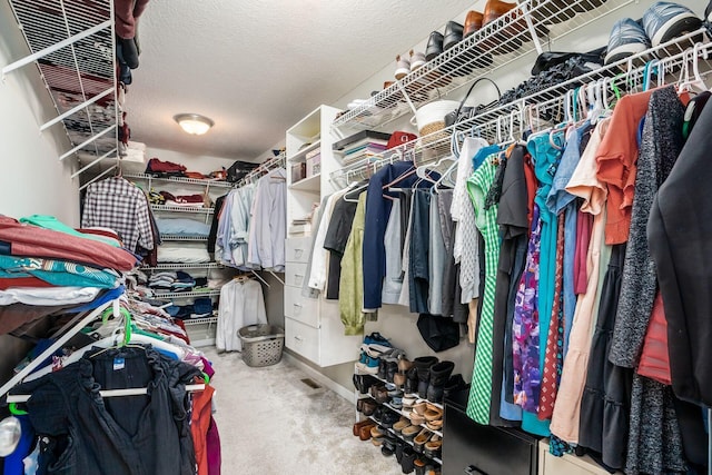 walk in closet with carpet floors and visible vents