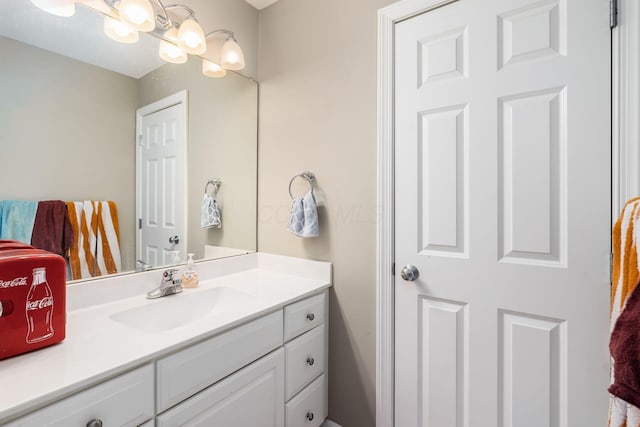 bathroom with a chandelier and vanity