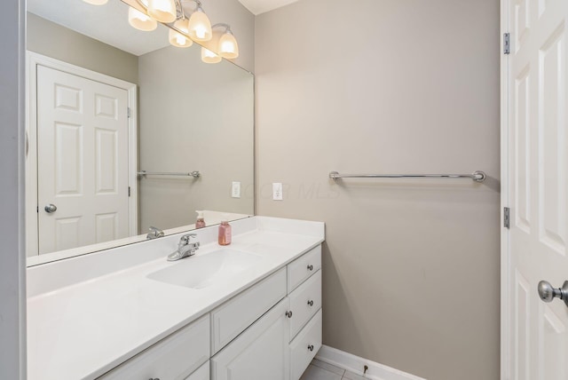 bathroom featuring an inviting chandelier, baseboards, and vanity