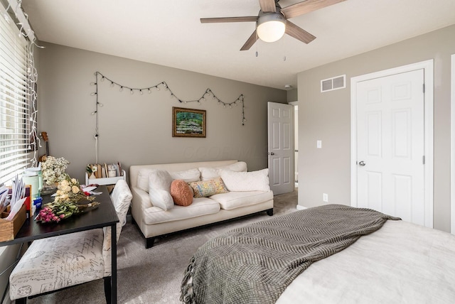 carpeted bedroom featuring visible vents and a ceiling fan