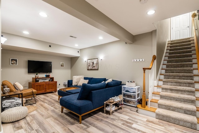 living area with stairway, light wood-type flooring, visible vents, and recessed lighting