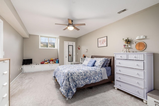 bedroom featuring light carpet, visible vents, and a ceiling fan