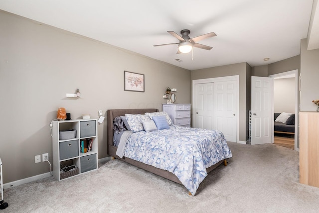 carpeted bedroom with ceiling fan, a closet, visible vents, and baseboards