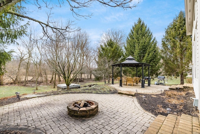 view of patio with an outdoor fire pit, a grill, and a gazebo