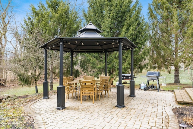 view of patio / terrace featuring a gazebo, outdoor dining space, and area for grilling