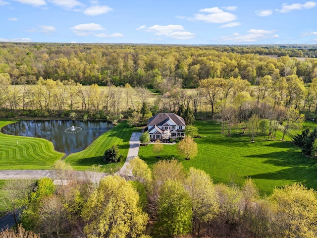 drone / aerial view featuring a water view and a forest view