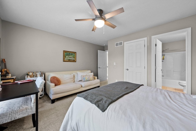 bedroom featuring visible vents, carpet, ceiling fan, and ensuite bath