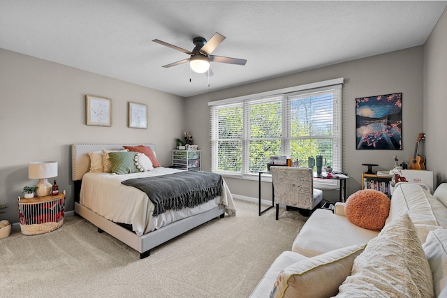 carpeted bedroom with a ceiling fan and baseboards