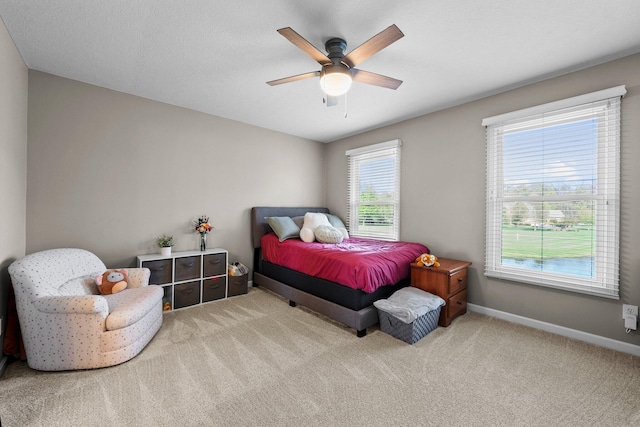bedroom with carpet flooring, a ceiling fan, and baseboards