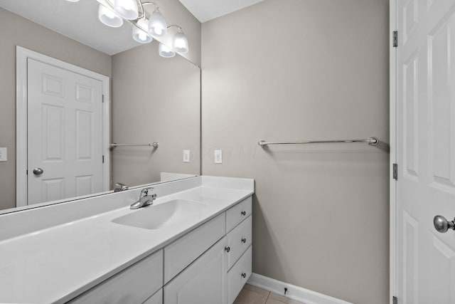 bathroom with tile patterned floors, baseboards, and vanity
